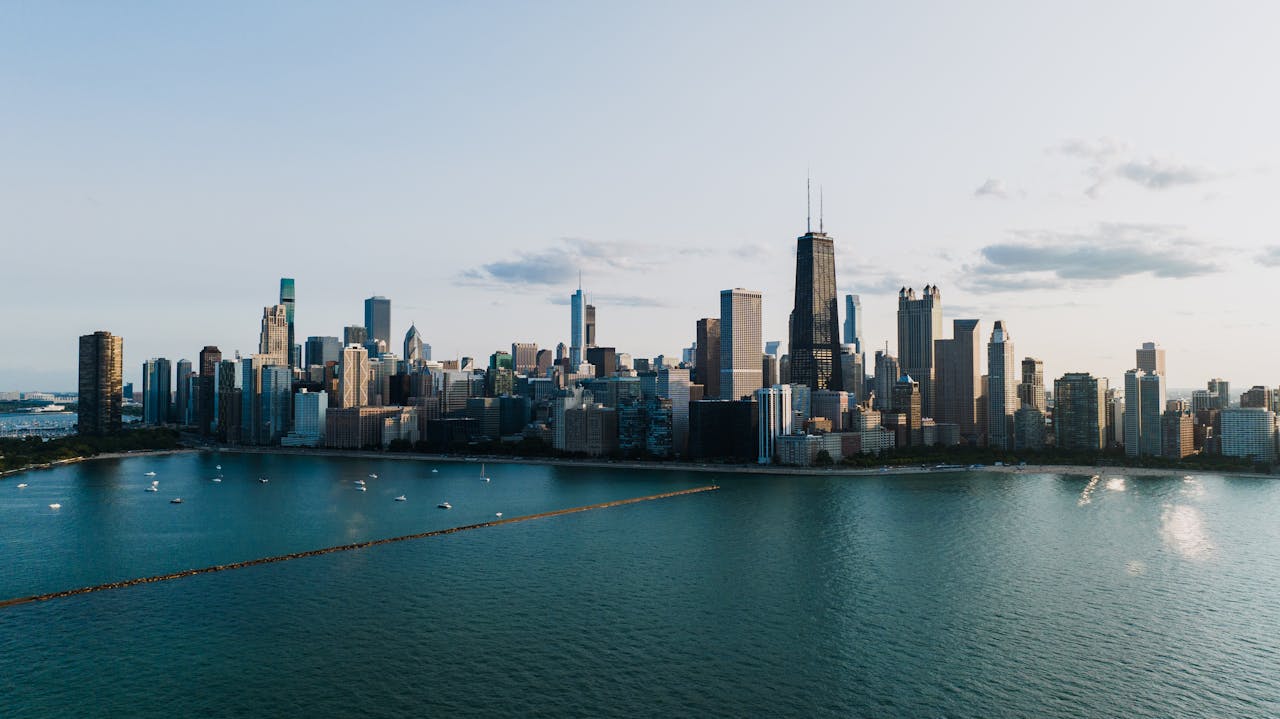 get-in-touch Stunning aerial view of the Chicago skyline with Lake Michigan in the foreground at dusk.