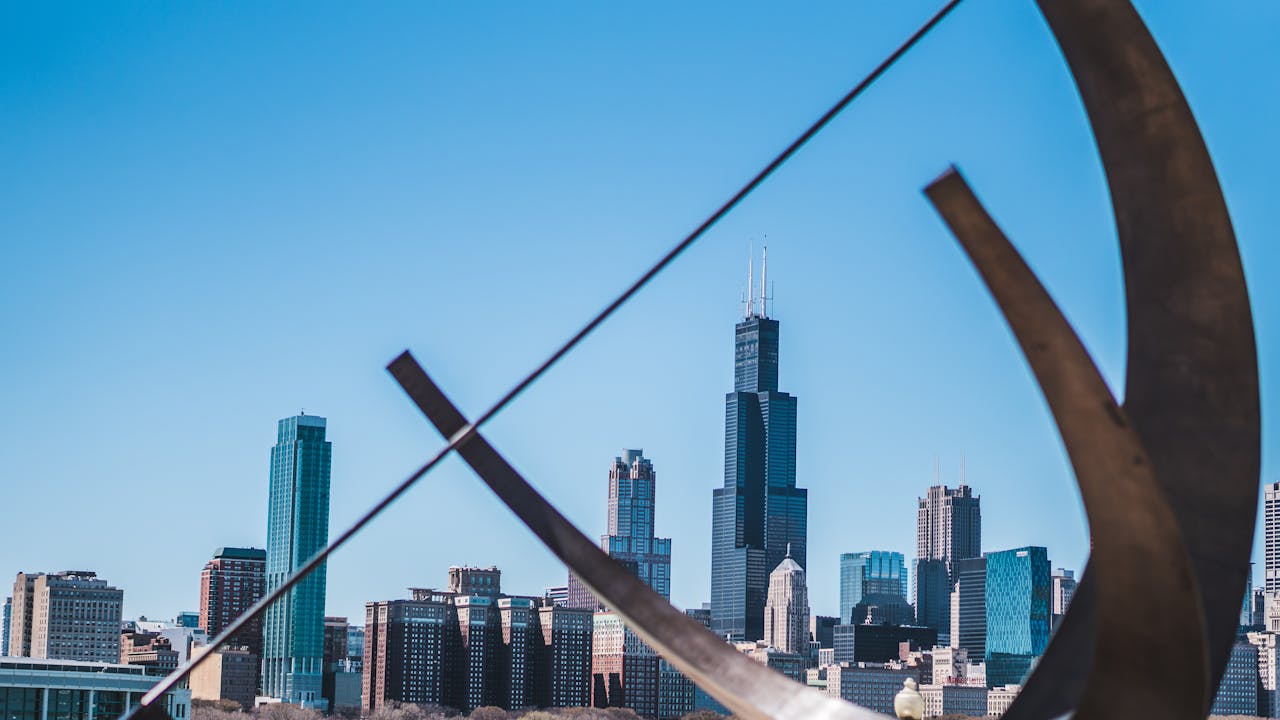 services-05 Stunning view of Chicago's skyline featuring the Willis Tower, with modern architecture and clear blue skies.